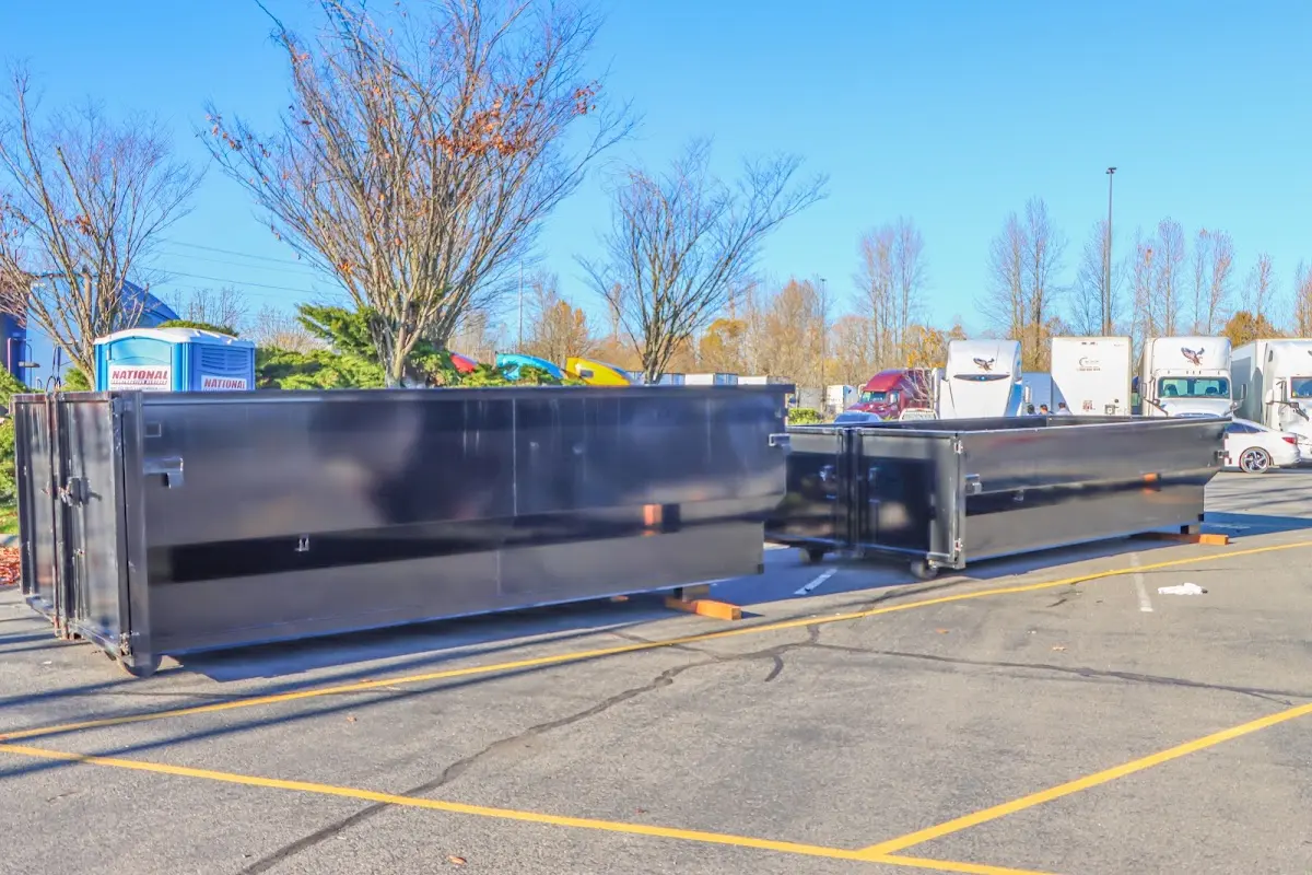 Professional dumpster rental service with roll-off container on residential driveway in Upper Arlington